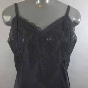 May include: Black lace slip with a V-neckline and adjustable straps.