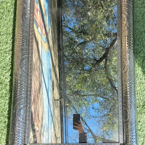May include: A white ceramic mug with a black handle and the text "But First, Coffee" in a bold, black font. The mug is set against a blurred background, suggesting a cozy setting. The mug appears to be approximately 4 inches tall.