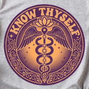 May include: A circular design with the words "KNOW THYSELF" in a golden-yellow color. The design features a caduceus symbol with wings, a lotus flower, and decorative elements in shades of purple and gold. The design is centered on a gray background.