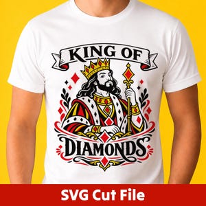 May include: A white t-shirt featuring a graphic illustration of a bearded king wearing a crown and holding a scepter. The design includes red and black diamond shapes, decorative flourishes, and the text "KING OF DIAMONDS" in black lettering.
