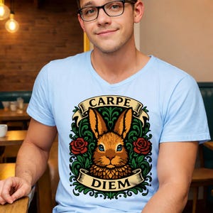 May include: A white ceramic mug with a black handle and the text "But First, Coffee" in a black, handwritten-style font. The mug is on a white surface.