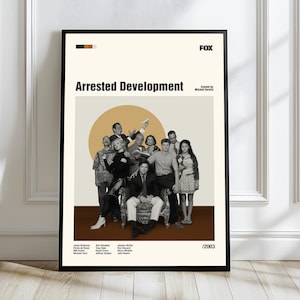 May include: A framed poster featuring the cast of the television show "Arrested Development." The poster has a beige background with the show's title in bold black letters. The cast is arranged in front of a large orange circle. The FOX logo is in the upper right corner.
