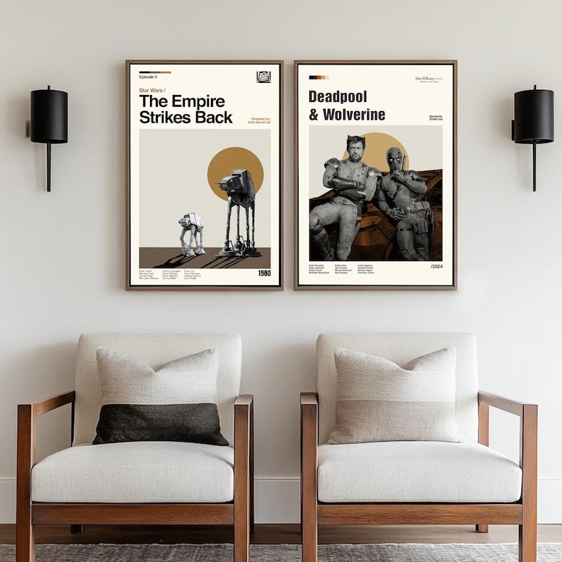 May include: Two framed movie posters. The left poster says "Star Wars / Episode V / The Empire Strikes Back" with an illustration of an AT-AT walker and an AT-ST. The right poster says "Deadpool & Wolverine" with illustrations of the characters.