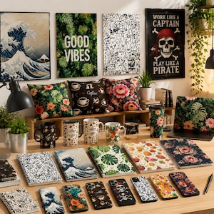 May include: A selection of homeware and office items with diverse designs. Includes cushions, mugs, notebooks, phone cases, and wall art. Designs feature floral patterns, coffee-themed graphics, and a pirate skull. The wall art includes a Japanese wave print.