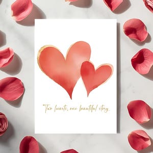May include: A white card with two watercolor hearts in shades of red and gold. The card is surrounded by scattered pink rose petals. The text "Two hearts, one beautiful story" is written in gold script.