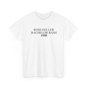 May include: A white t-shirt with the text "ROSS GELLER BACHELOR BASH 1998" printed in black. The shirt is a crew neck style and appears to be made of a soft material. The text is centered on the front of the shirt.