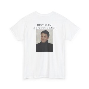 May include: White t-shirt featuring a portrait of Joey Tribbiani from the TV show Friends. The text "BEST MAN JOEY TRIBIANI" is printed above the image. The image is a portrait of the actor Matt LeBlanc.