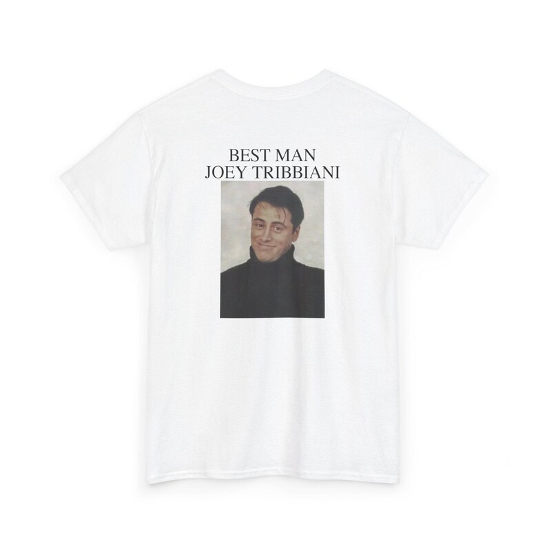 May include: White t-shirt featuring a portrait of Joey Tribbiani from the TV show Friends. The text "BEST MAN JOEY TRIBIANI" is printed above the image. The image is a portrait of the actor Matt LeBlanc.