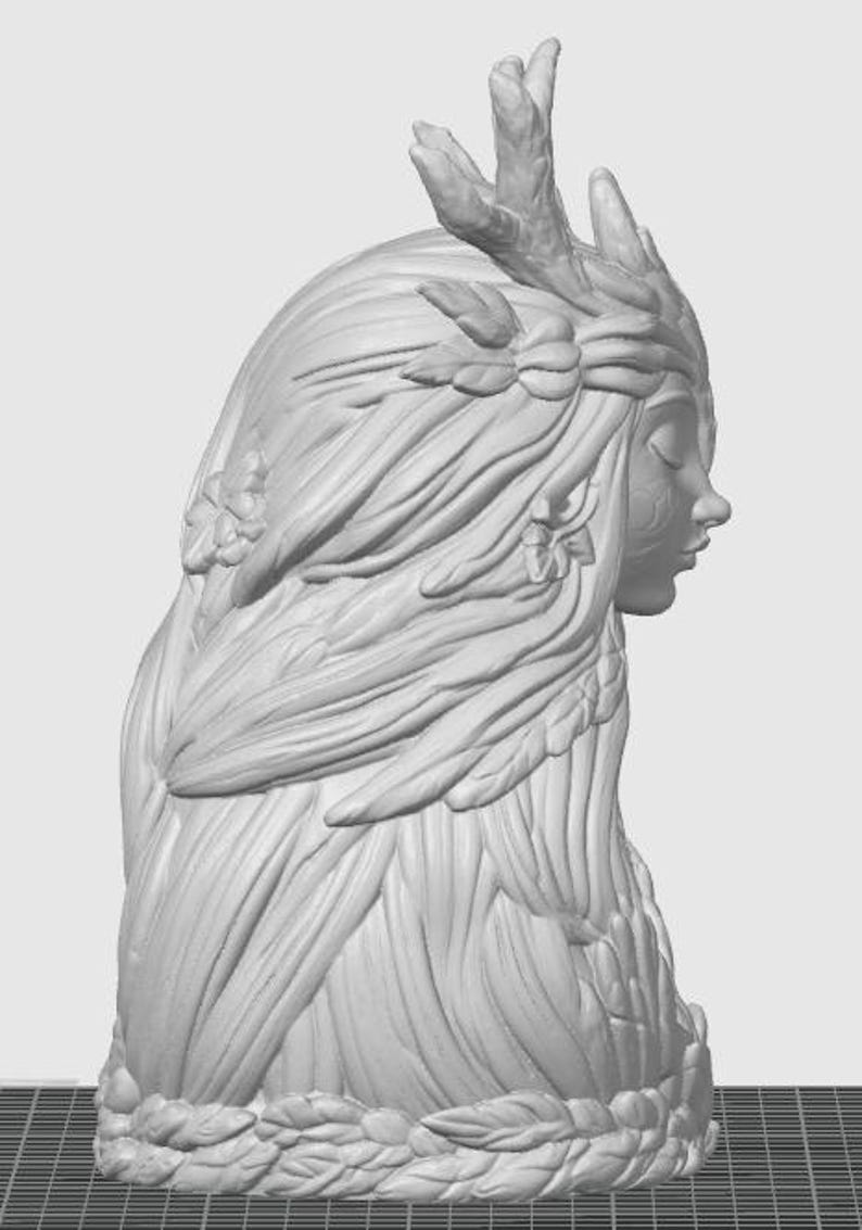 May include: A light gray monochromatic 3D sculpture of a profile bust featuring a figure with long flowing hair adorned with leaves and flowers. The figure has closed eyes and prominent antlers extending from the top of the head, with a base of leaves.
