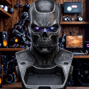 May include: A metallic skull bust with glowing purple and blue eyes. The bust has a detailed circuit board design on the forehead and a tray-like opening at the chest. The background features wooden shelves with electronic components.