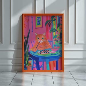 May include: A framed art print featuring a ginger cat enjoying sushi at a blue table. The cat holds chopsticks, with sushi rolls and a bowl visible. The background is a vibrant pink with plants and artwork. The frame is orange.