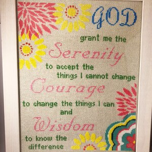 May include: A framed cross-stitch with a floral design and the text "GOD grant me the Serenity to accept the things I cannot change Courage to change the things I can and Wisdom to know the difference".
