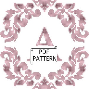 Puede incluir: Un patrón de punto de cruz rosa y blanco con un diseño floral. El patrón tiene forma de círculo y tiene una etiqueta "PDF PATTERN" en el centro.