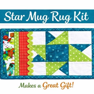 May include: A rectangular mug rug kit with a star design. The rug features a teal border, white, green, and teal star pattern, and red and green accents. Text at the top reads "Star Mug Rug Kit" and at the bottom "Makes a Great Gift!"