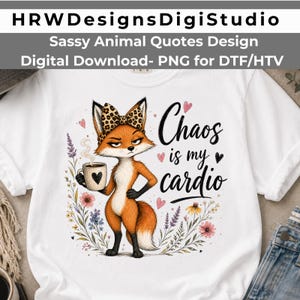 May include: A white t-shirt featuring a graphic of an orange fox wearing a leopard print bow, holding a coffee mug with a heart. The text reads Chaos is my cardio, surrounded by colorful floral illustrations and small pink and black hearts.