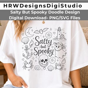 May include: White t-shirt with a black doodle design featuring a crescent moon, bat, seashells, anchor, crabs, lighthouse, and a ghost wearing a hat. The text "Salty but Spooky" is also included in the design.