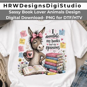 May include: A white t-shirt featuring a graphic of a donkey wearing a pink polka-dot bow, holding a coffee mug, and reading a book. The text reads, I annotate my books and my opinions, surrounded by colorful sticky notes, flowers, and a stack of books.