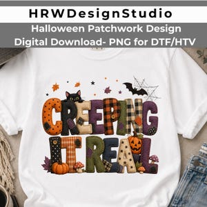 May include: A white t-shirt featuring a colorful Halloween-themed graphic with the text "CREEPING IT REAL" in a patchwork style. The design includes a black cat, pumpkins, mushrooms, a bat, spiderwebs, and autumn leaves in orange, black, and purple.