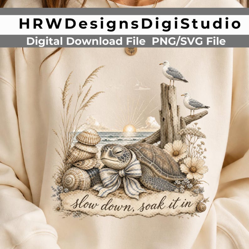 May include: A cream-colored sweatshirt featuring a graphic of a sea turtle wearing a striped bow, stacked seashells, tall beach grass, two seagulls perched on driftwood, and flowers. The text reads: HRWDesignsDigiStudio, Digital Download File PNG/SVG File, slow down, soak it in.
