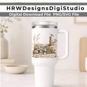 May include: A white insulated tumbler with a handle and clear lid featuring a printed graphic of a sea turtle, seashells, seagulls, and tall grass on a beach at sunrise with the text "slow down, soak it in" written in a cursive script font.