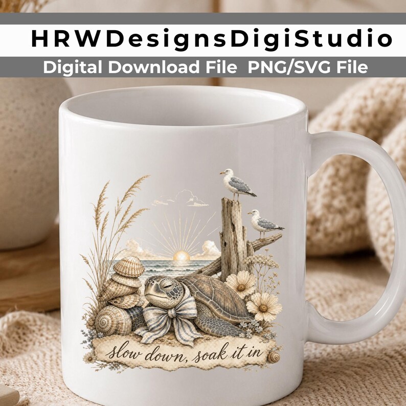 May include: A white ceramic mug featuring a graphic of a sea turtle wearing a bow, stacked seashells, tall beach grass, two seagulls perched on driftwood, and a sunrise over the ocean, with the text "slow down, soak it in" printed below.