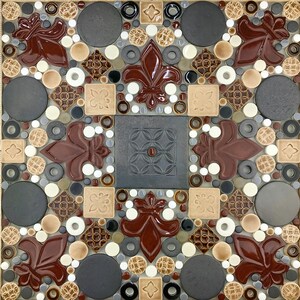 May include: A decorative tile mosaic with a geometric pattern featuring brown, white, and gray tiles. The center of the mosaic features a dark gray square tile with a floral design.