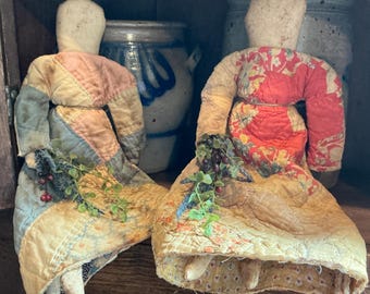 Primitive prairie doll with antique quilt dress and wild flower posey.