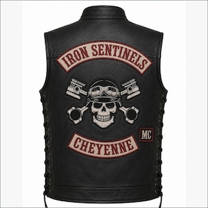 May include: A black leather waistcoat featuring side lacing and large embroidered patches on the back. The top patch reads IRON SENTINELS, while the bottom patch reads CHEYENNE. A central graphic depicts a skull wearing goggles with crossed pistons.