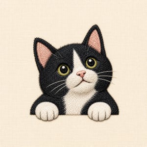 May include: An embroidered patch featuring a black and white tuxedo cat with large green eyes, a pink nose, and white paws. The cat is depicted from the chest up, with its front paws resting as if peering over an edge, set against a cream background.