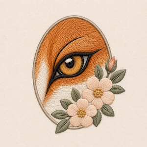 May include: An oval embroidered patch featuring a detailed close-up of a fox eye with orange and white fur texture. The design is accented with two light pink flowers, a small flower bud, and several sage green leaves on a cream fabric background.