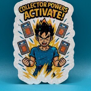 May include: Holographic sticker featuring a cartoon character with spiky black hair and a blue shirt, surrounded by energy bursts and trading card images. The sticker reads "COLLECTOR POWERS ACTIVATE!"