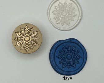 May include: A collection of wax seals with snowflake designs. One is gold, one is pearl, and one is navy blue. The word "Pearl" is above the pearl seal, and the word "Navy" is below the navy seal.