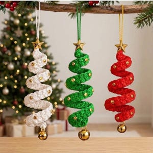 May include: Three spiral-shaped Christmas tree ornaments made of crocheted yarn in white, green, and red. Each ornament features a gold star at the top, small gold beads embedded along the spiral, and a gold jingle bell hanging at the bottom.