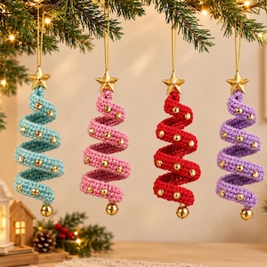 May include: Four spiral-shaped Christmas tree ornaments made of crocheted yarn in light blue, pink, red, and purple. Each ornament features a gold star at the top, small gold beads along the spiral, and a gold bell at the bottom hanging by a cord.