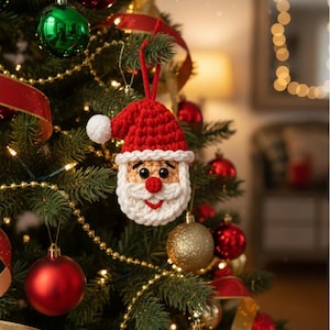 May include: A Christmas tree decorated with red, green, and gold ornaments, and gold ribbon. A handmade crochet Santa Claus ornament hangs from the tree. The Santa ornament has a red hat, white beard, and a smiling face.