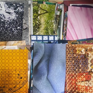 May include: A collection of assorted rectangular paper prints and magazine clippings featuring diverse imagery, including a black and white graphic pattern, a green forest landscape, a pink gradient, a yellow geometric print, and blue fabric.