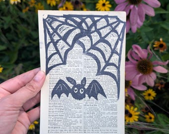 Cute Bat with Spiderwebs - 5x7 Hand-Carved Linocut Print on Vintage Dictionary Pages