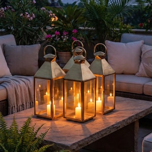 Handmade solid brass lantern candle holder with clear glass panels and polished brass finish