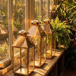 Handmade solid brass lantern candle holder with clear glass panels and polished brass finish