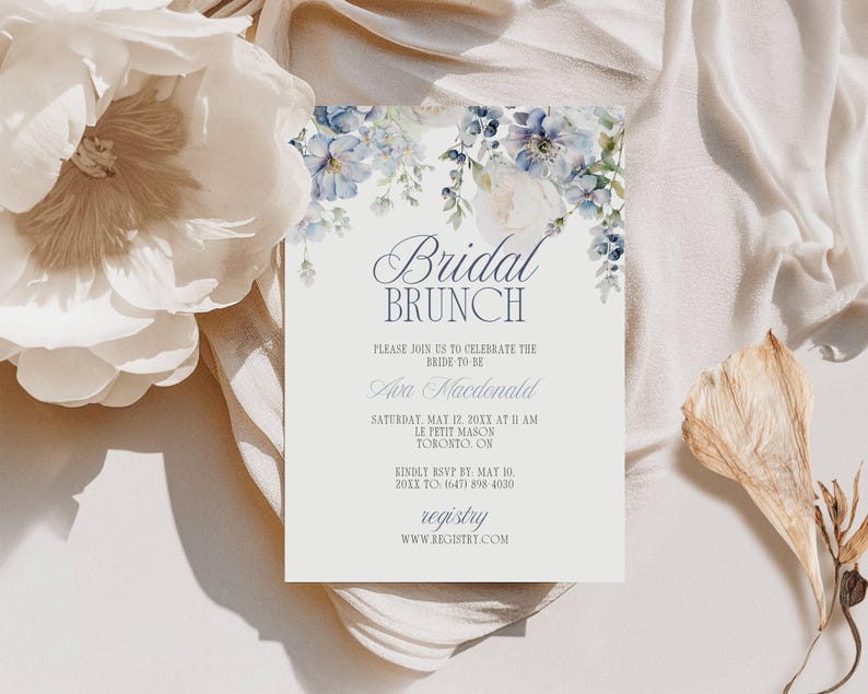 May include: A bridal brunch invitation with floral accents. The invitation features the text "Bridal Brunch" and details for the event, including the bride's name, date, time, and location. The design includes watercolor-style blue and white flowers.