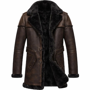 May include: A brown leather coat with a black shearling lining and collar. The coat has a button-up front, two pockets, and a classic, long design. The sleeves have black shearling cuffs. A warm winter coat.