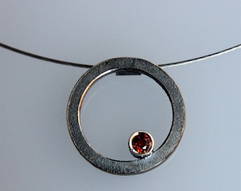 Contemporary handmade silver pendant "Q " oxidized with garnet