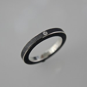 Stacking ring in black ( oxidized ) silver with a white diamond