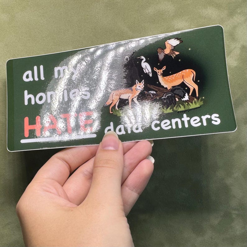 May include: A rectangular sticker with a dark green background featuring the white text "all my homies" and "data centers" with the word "HATE" in red. The design includes illustrations of a fox, a deer, a bird, and a heron in a forest.