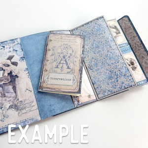 May include: A blue and white patterned scrapbook with a small, cream-colored journal that says "Observations" on the cover. The journal has a decorative letter "A" on the front.