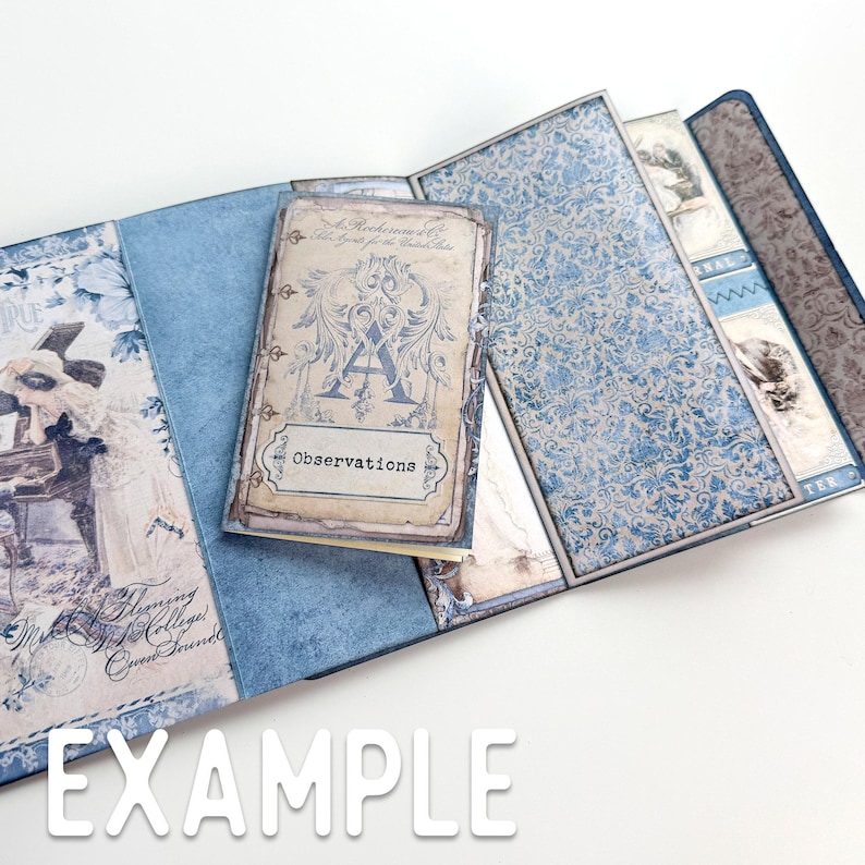 May include: A blue and white patterned scrapbook with a small, cream-colored journal that says "Observations" on the cover. The journal has a decorative letter "A" on the front.