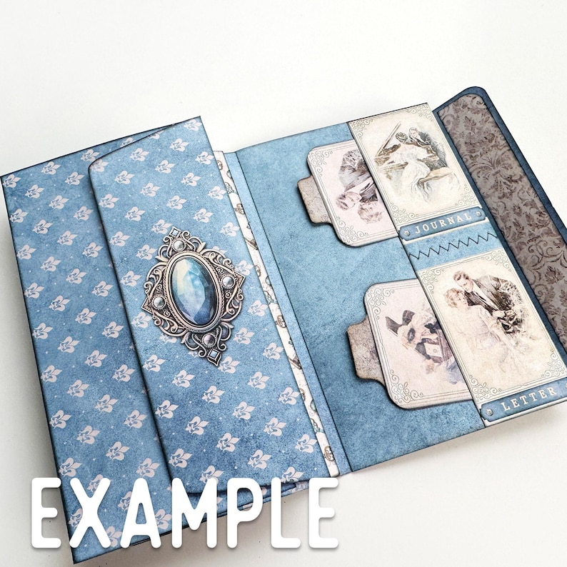May include: A blue and white patterned paper folder with a decorative jeweled embellishment. The folder has two pockets labeled "Journal" and "Letter".