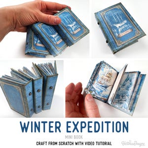 Może przedstawiać: Miniaturowa książka zatytułowana Winter Expedition z niebieską okładką, złotymi ozdobnymi obramowaniami i centralną ilustracją żaglowca. Wewnętrzne strony zawierają szczegółowe wydruki przedstawiające statki w lodowych krajobrazach.