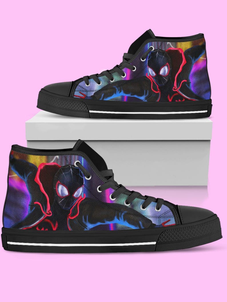 May include: Pair of high-top canvas sneakers featuring a colorful graphic of a superhero. The shoes have black soles, black laces, and silver eyelets. The design includes shades of red, blue, and purple against a black background.