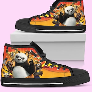 May include: High-top canvas trainers with a colourful design featuring a panda and other characters set against a sunset background. The trainers have black soles, laces, and toe caps, with a white midsole.